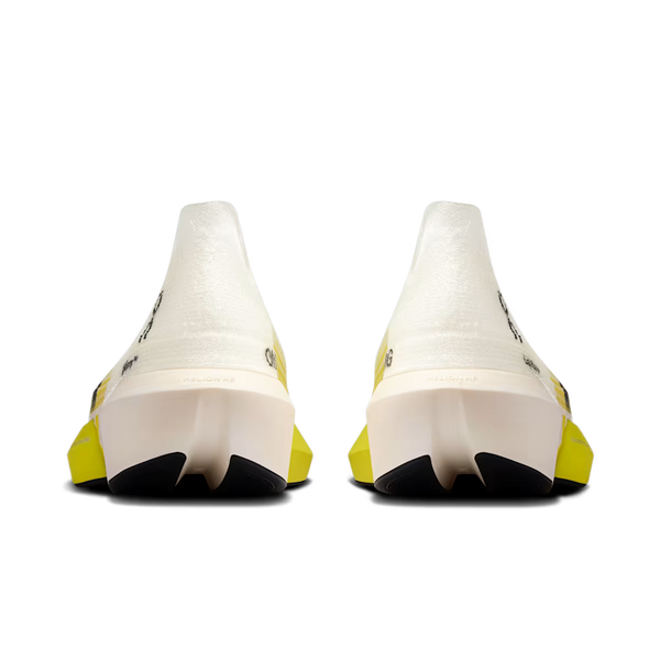 A pair of white athletic shoes shown from the back, featuring a chunky white midsole, black outsole sections, and bright yellow heel accents on a plain white background.