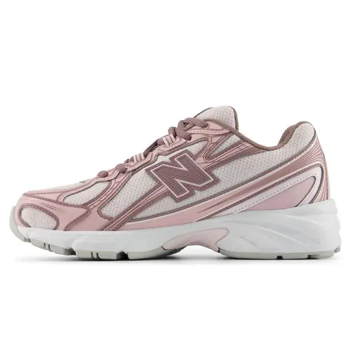 A New Balance athletic sneaker in dusty pink and white, shown against a plain white background.