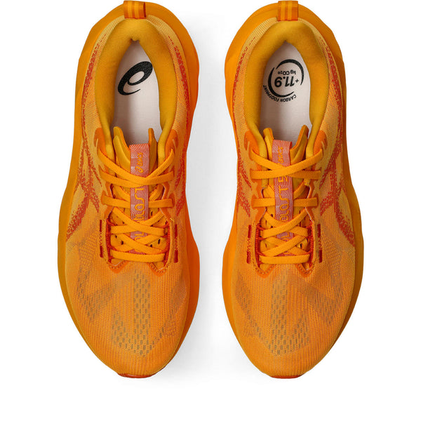 Pair of orange running shoes on a white background