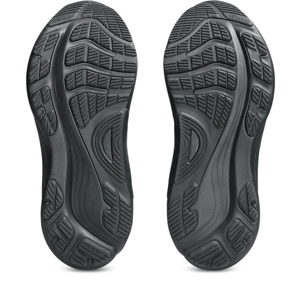 Close-up of black shoe soles with tread pattern on a white background