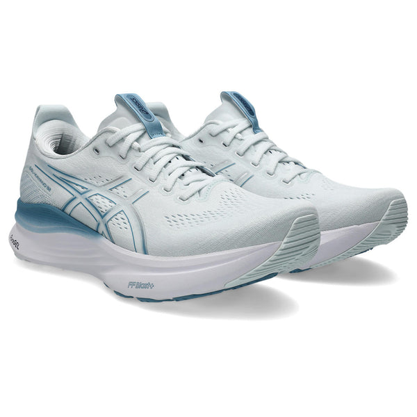 White running shoes with blue accents on a white background