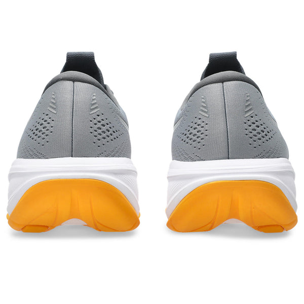 Gray running shoes with orange soles on a white background.