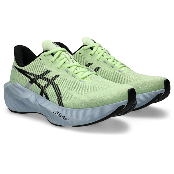 Pair of green running shoes with black accents on a white background