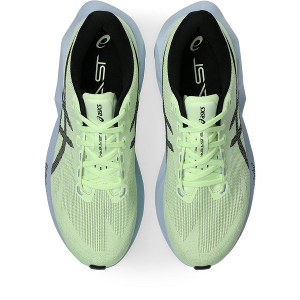 Pair of green running shoes with black accents on a white background