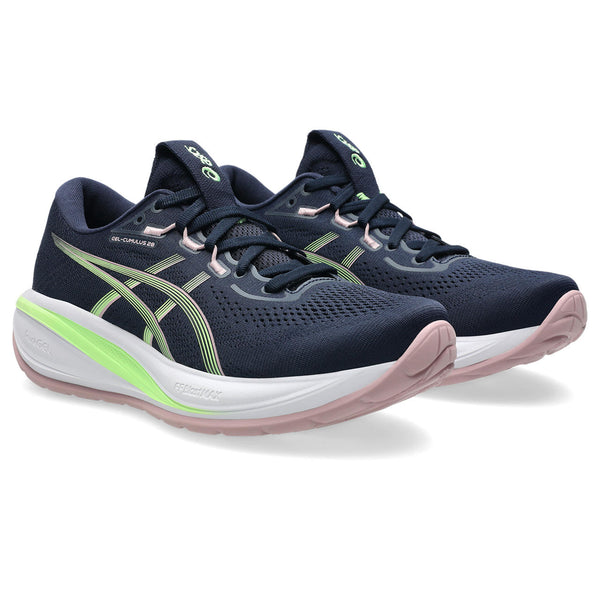 Navy running shoes with green accents on a white background