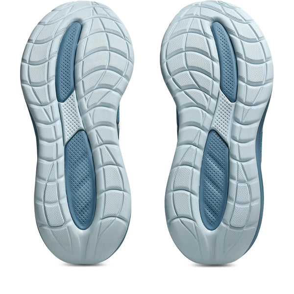 Close-up of a pair of light blue athletic shoes with tread pattern on a white background