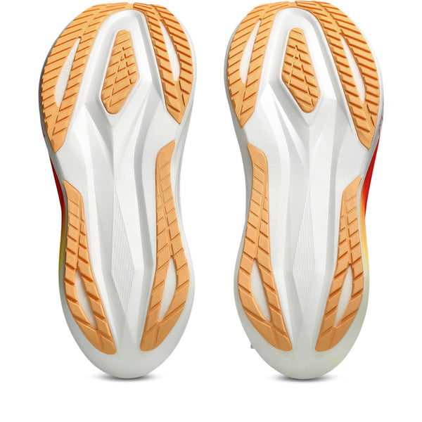 Pair of white and orange athletic shoes on a white background