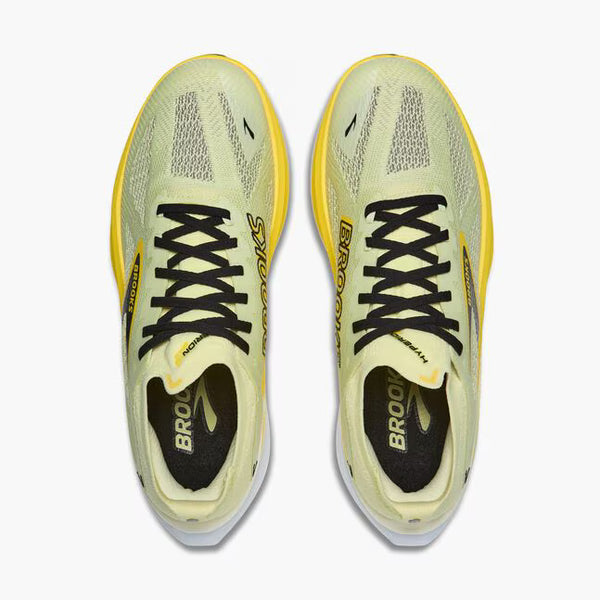 Yellow running shoe with black accents on a white background