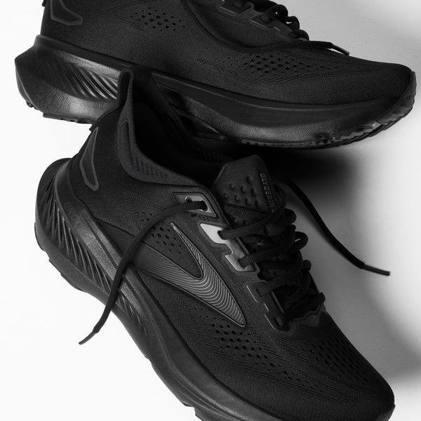 Black athletic shoes on a light gray background