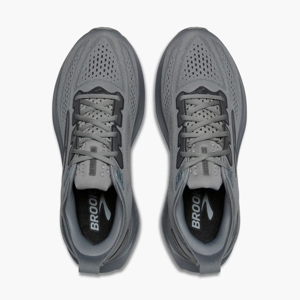 Pair of gray running shoes with 'Brooks' branding on a white background