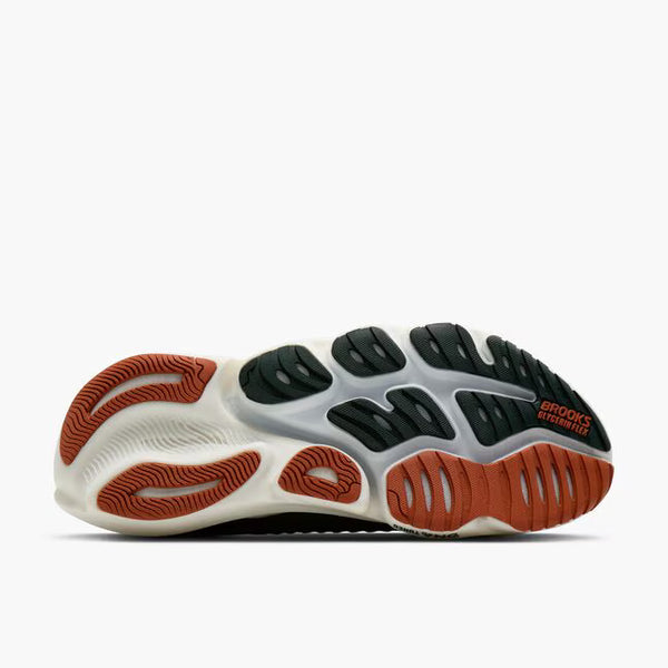 A dark green running shoe with a white midsole and orange outsole accents, shown on a light gray background.