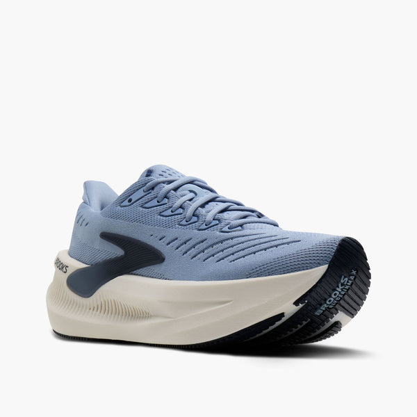 Blue running shoe with a white sole on a white background