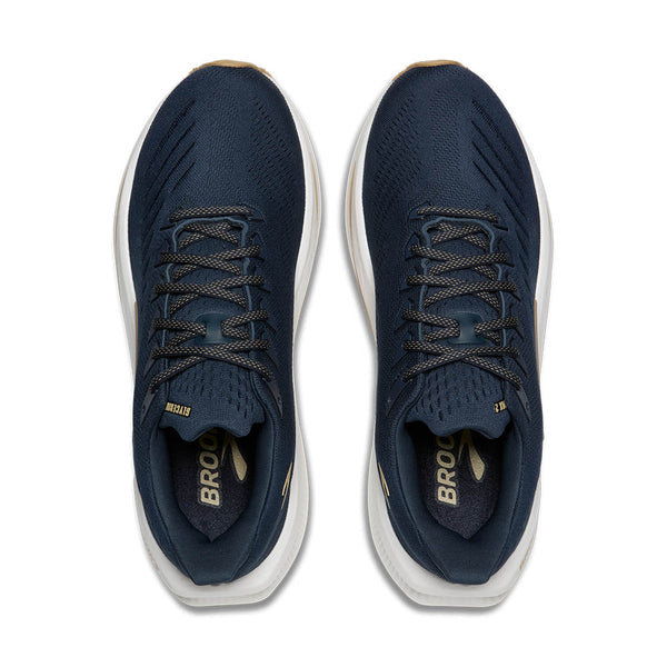 Pair of navy blue athletic shoes with white soles on a white background