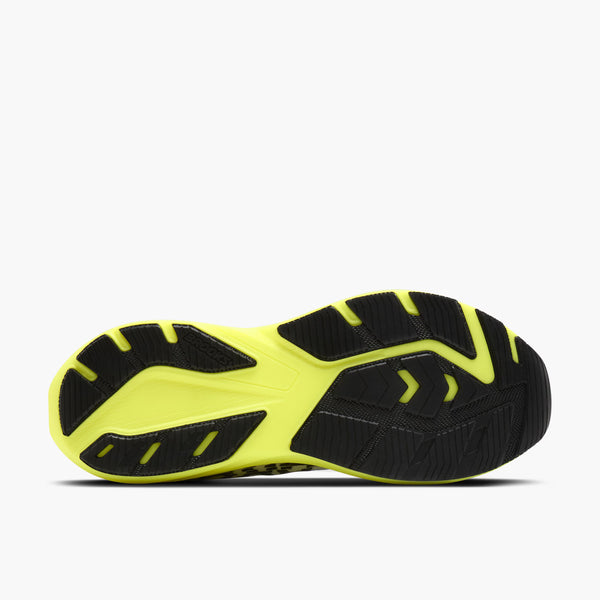 The outsole of a running shoe shown from a top-down view, featuring a bright neon yellow-green and black tread pattern on a light gray background.
