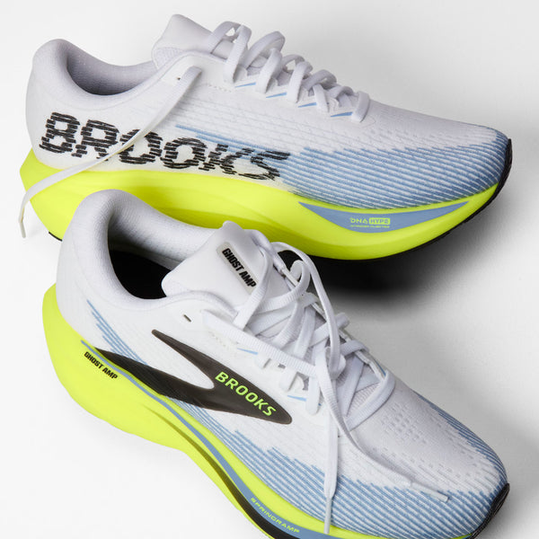 Two Brooks Ghost 140 running shoes in white, light blue, and neon yellow, shown from different angles on a light gray background.