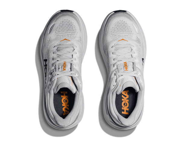 Hoka is printed on the tongue of the shoe in orange lettering.
