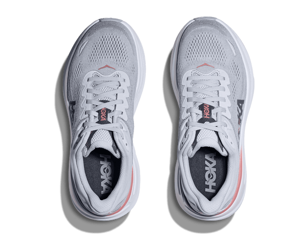 Pair of white running shoes with visible Hoka branding on a transparent background