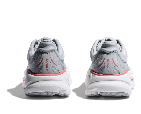 Pair of gray running shoes with pink accents on a transparent background