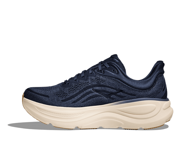 Navy running shoe with white sole on a transparent background