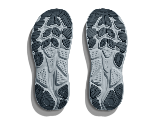 Top view of a pair of gray athletic shoes with tread pattern on a transparent background
