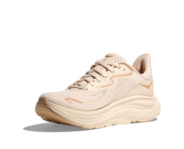 The Hoka logo is stitched near the ankle on the medial side of the upper in a peach colored thread.
