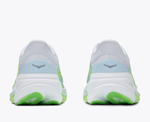White running shoes with green and blue accents on a white background