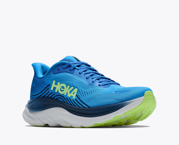 Blue running shoe with green sole on a white background