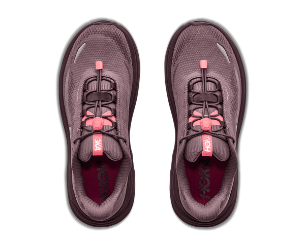 A pair of Hoka hiking shoes shown from a top-down view, featuring a dusty purple mesh upper with black laces and pink accents