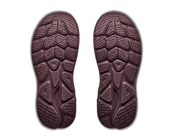 A pair of dark brown shoe soles shown from above displaying detailed tread patterns.