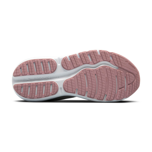 Close-up of a shoe sole with pink tread pattern on a white background.