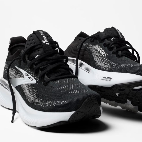 Black and white running shoes with 'Brooks' branding on a white background