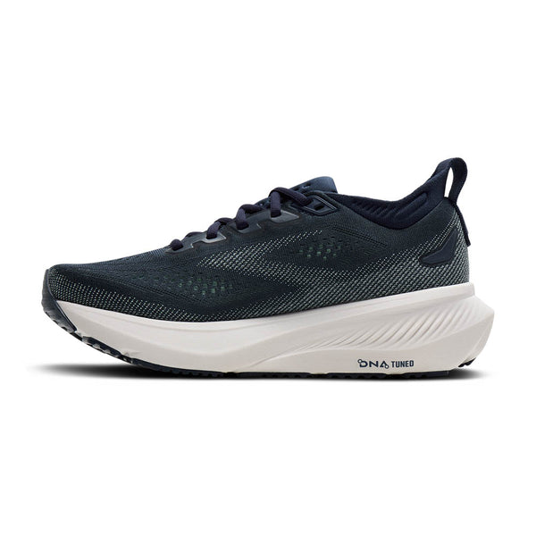 Medial side of navy running shoe with white sole on a white background.