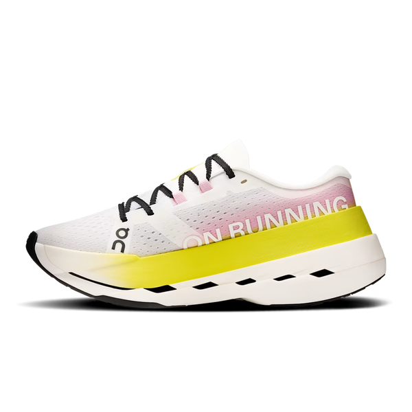 White running shoe with yellow sole on a white background