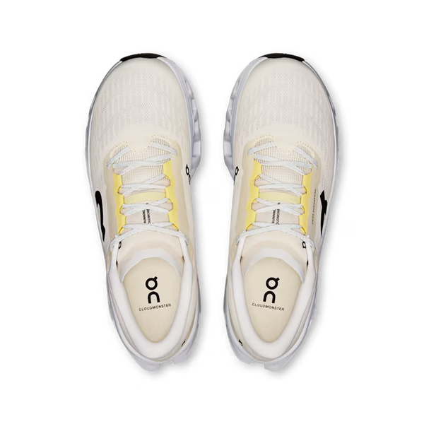 A pair of On Cloudrunner sneakers shown from a top-down view, featuring a cream-colored mesh upper, white laces, yellow accents on the eyelets, and black branding details.