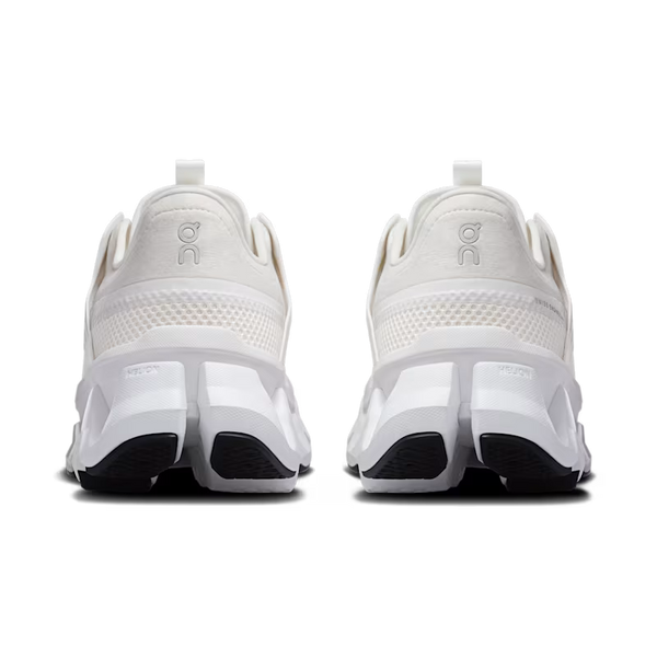 White running shoes with black soles on a white background