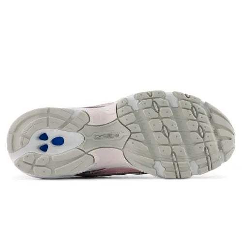 A New Balance athletic sneaker in dusty pink and white, shown against a plain white background.