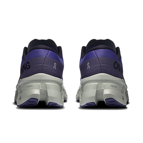 Back view of black and purple running shoes on a white background