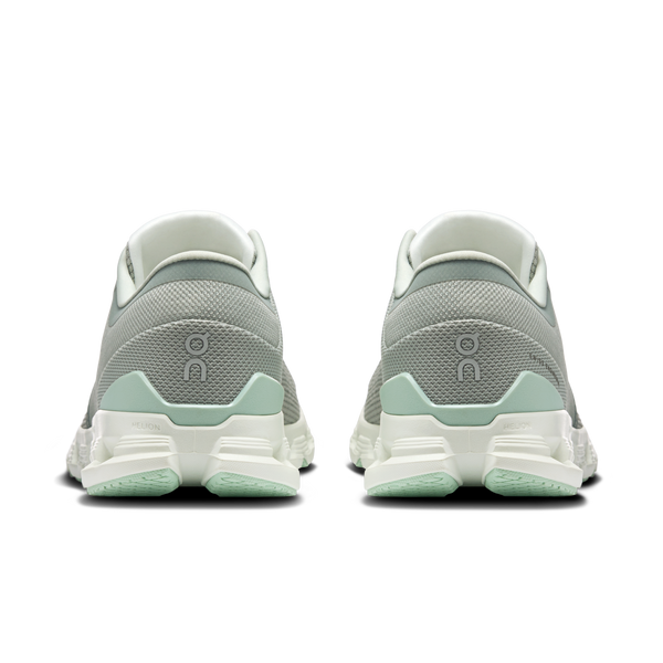 Green running shoes with a visible brand logo on a white background