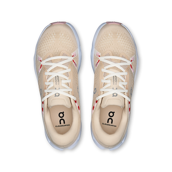 Beige running shoes with white laces on a white background