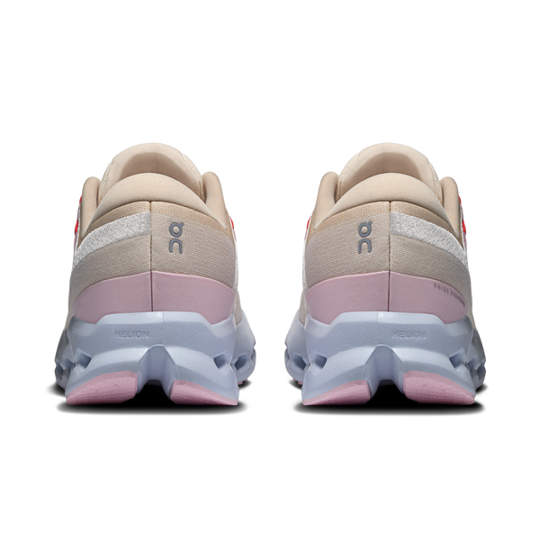 Pair of beige and pink running shoes on a white background