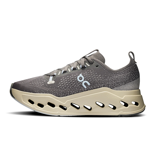 Gray running shoe with beige sole on a white background.