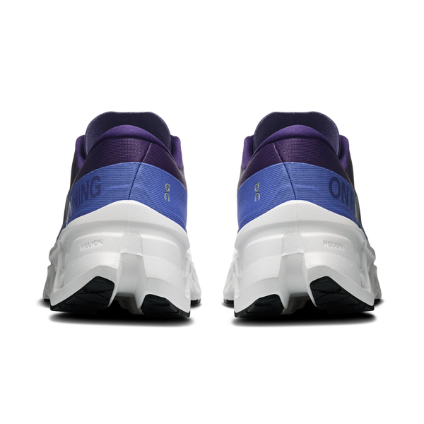 Purple and blue running shoes with white soles on a white background