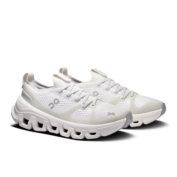 A pair of white On running shoes with a chunky, wavy sole and light gray accents, photographed on a clean white background.