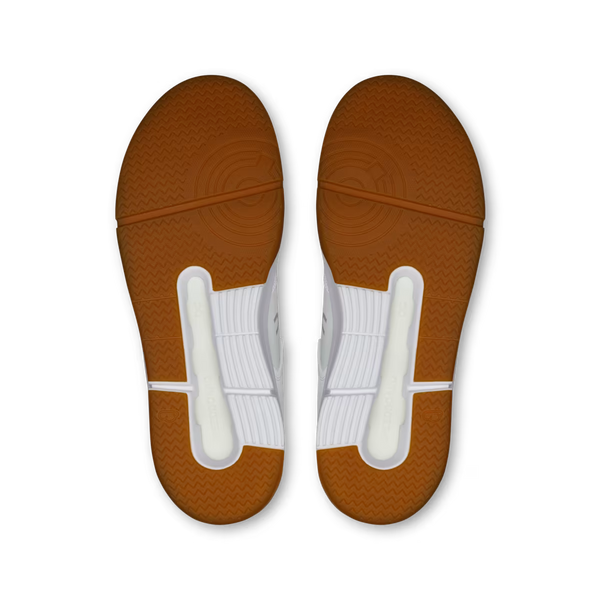 White sneaker with brown sole on a white background