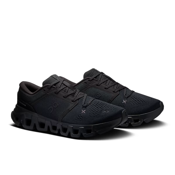 A pair of black On running shoes with a textured mesh upper and a chunky, sculpted black sole, shown against a plain white background.