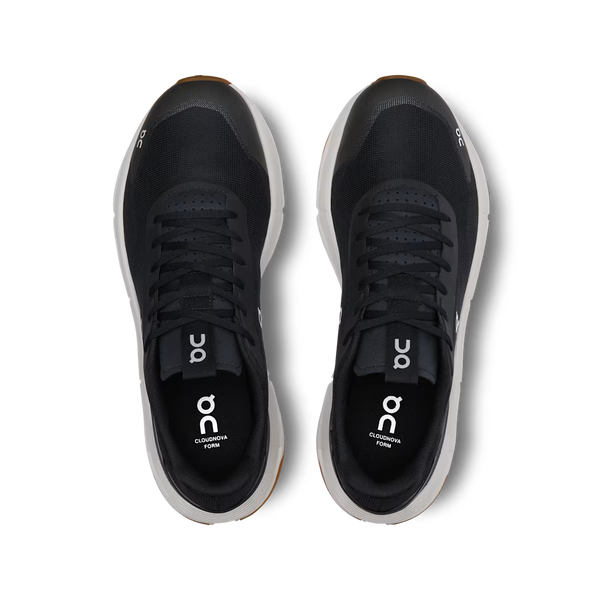 Black running shoe with white sole on a white background