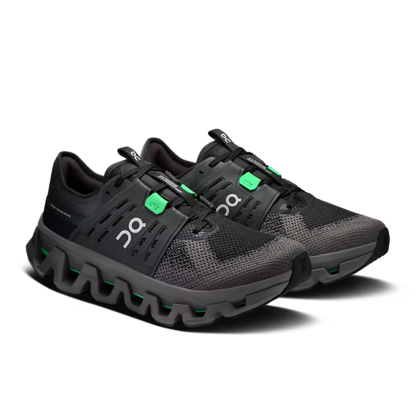 A pair of black On fashion shoes with bright green accents and white logo details, displayed on a clean white background.