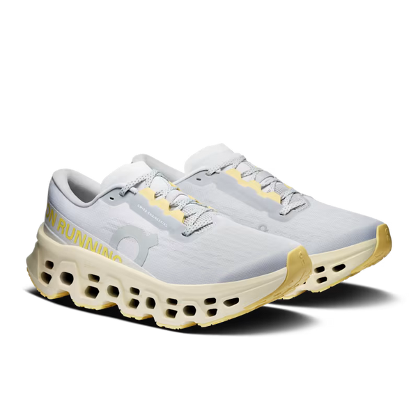 White running shoes with yellow accents on a white background