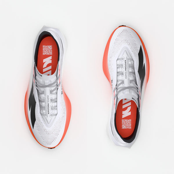 White running shoes with black and orange accents on a white background