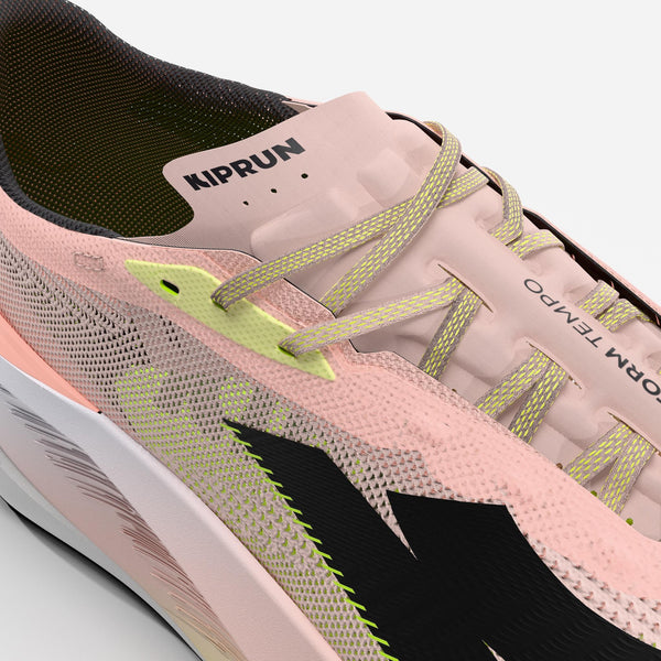 Pink running shoe with green accents and 'KIPRUN' branding on a white background